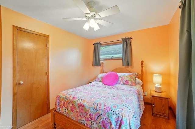 bedroom with wood finished floors and a ceiling fan