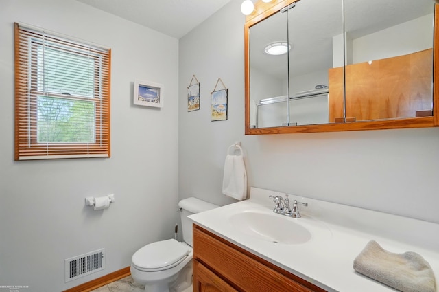 bathroom featuring toilet, visible vents, baseboards, and vanity