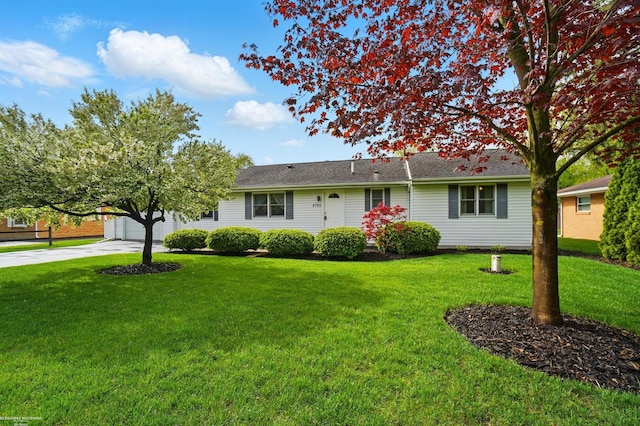 ranch-style house with a garage, a front yard, and driveway