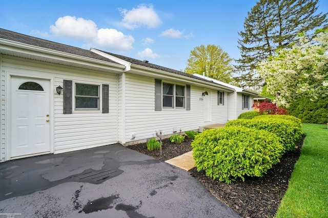 view of side of property with a shingled roof