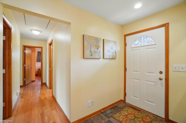 entryway with baseboards and wood finished floors
