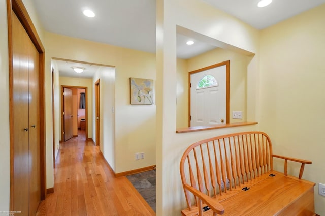 corridor with baseboards, recessed lighting, and wood finished floors