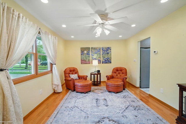 sitting room with wood finished floors, ceiling fan, and recessed lighting