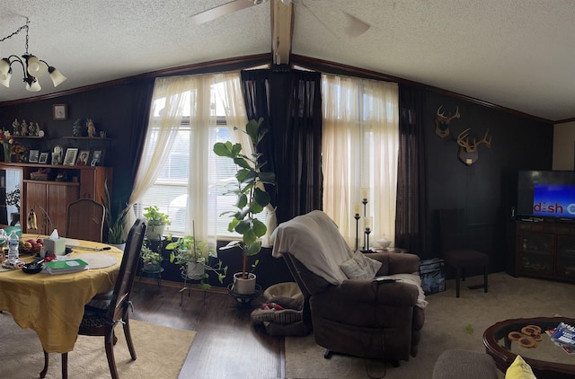living room with a textured ceiling, ornamental molding, and plenty of natural light