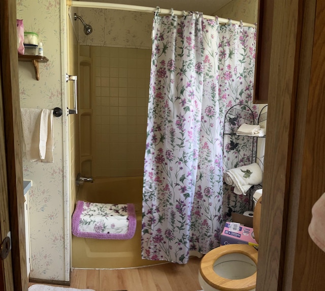 bathroom with shower / bath combination with curtain and wood finished floors