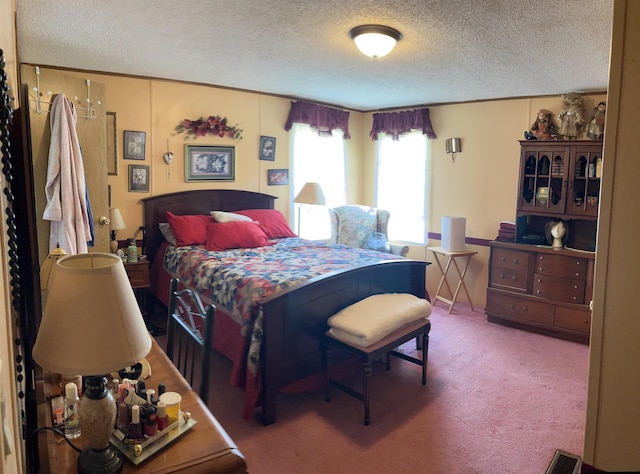 carpeted bedroom with a textured ceiling and visible vents
