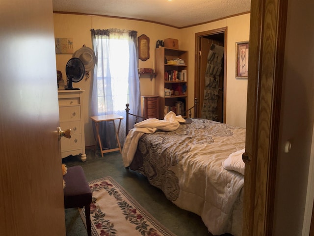 bedroom with carpet flooring, crown molding, and a textured ceiling