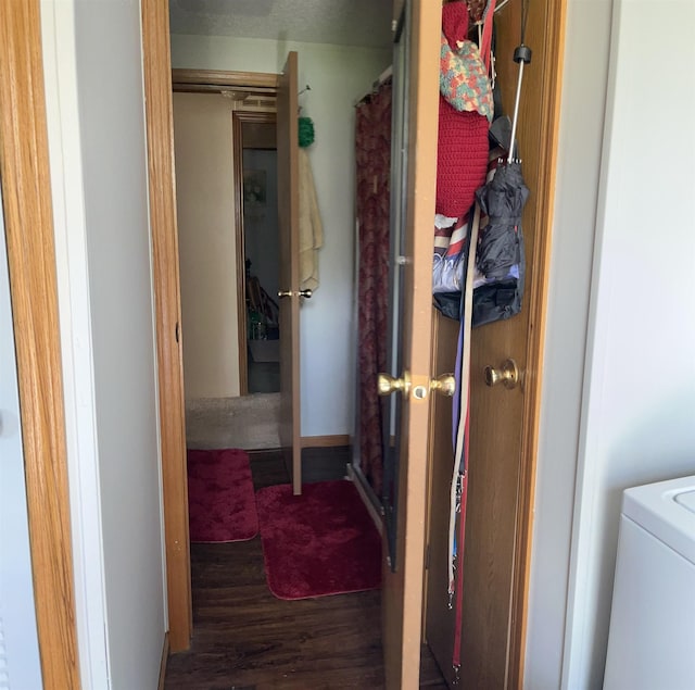 corridor with washer / clothes dryer and wood finished floors