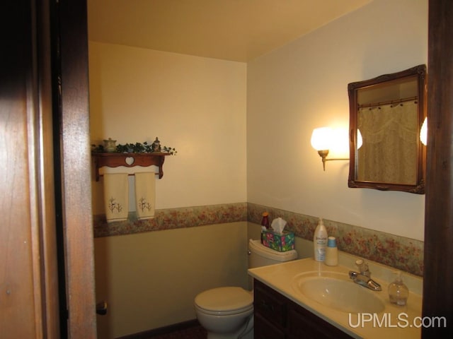 bathroom with toilet and vanity