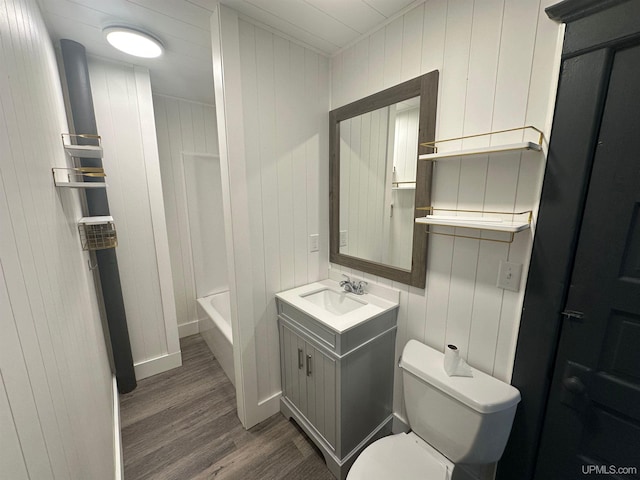 full bathroom with toilet, vanity, and wood finished floors