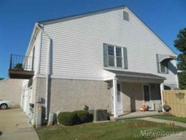 view of side of home with fence