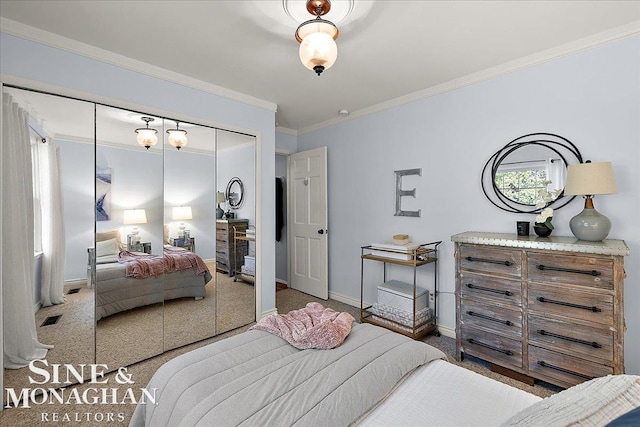 bedroom with a closet, ornamental molding, carpet flooring, and baseboards