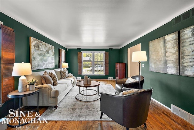 living room featuring wood finished floors and baseboards