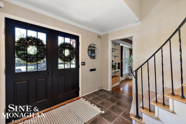 entrance foyer featuring stairs, ornamental molding, and baseboards