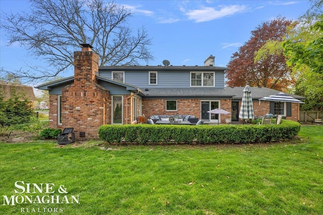 back of house featuring a chimney, an outdoor living space, and brick siding