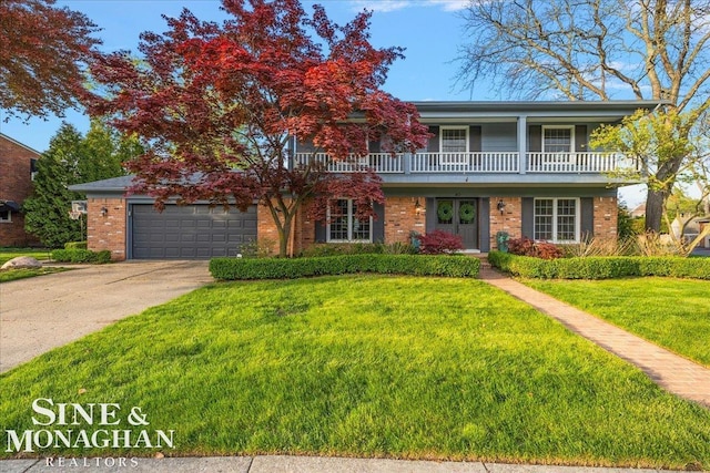 traditional-style home with a front lawn, driveway, brick siding, and a garage
