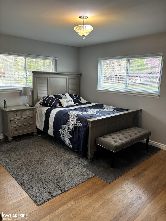 bedroom featuring wood finished floors and baseboards