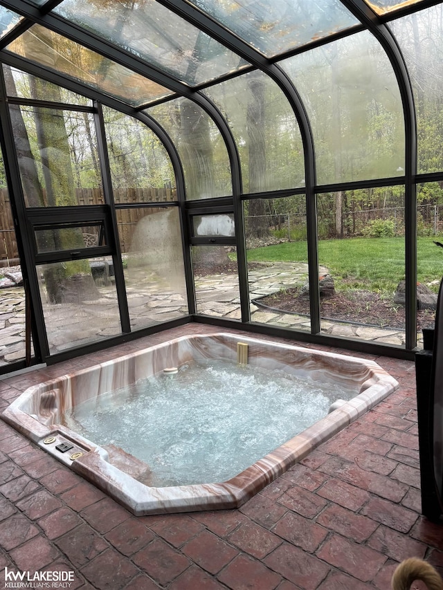 unfurnished sunroom with a jacuzzi
