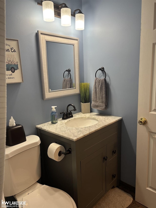 bathroom featuring toilet and vanity