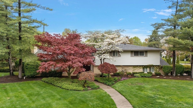 tri-level home with a front lawn