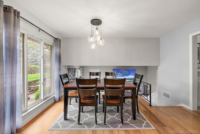 dining space featuring wood finished floors and baseboards