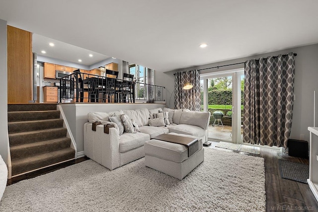 living room featuring stairway, recessed lighting, and wood finished floors