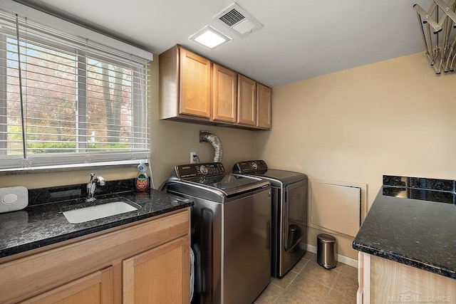 laundry room with cabinet space, washer and clothes dryer, light tile patterned floors, and baseboards