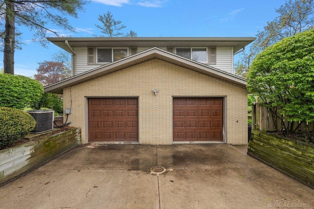 garage with cooling unit and driveway
