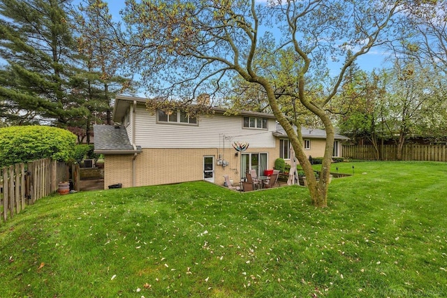 rear view of property with brick siding and a patio area