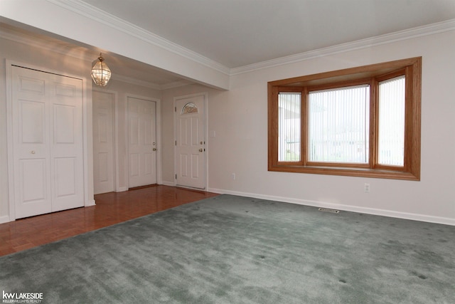 carpeted entryway with crown molding and baseboards