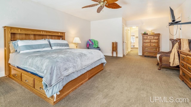 bedroom with light colored carpet, a ceiling fan, and baseboards