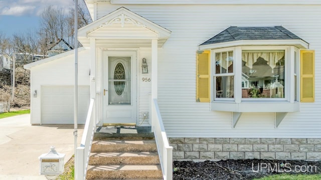 property entrance featuring driveway and a garage