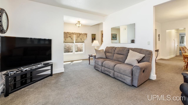 living room with carpet and baseboards