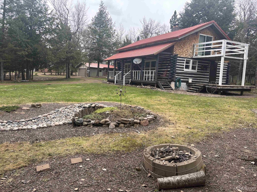 1450 5th St, Wakefield, MI 49968 - view of green lawn with stairway, an outdoor fire pit, and a deck
