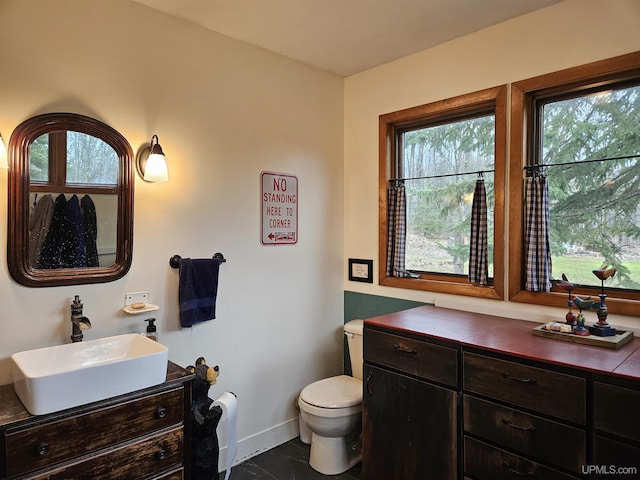 N15505 Black River Rd, Ironwood, MI 49938 - bathroom featuring vanity, toilet, and baseboards
