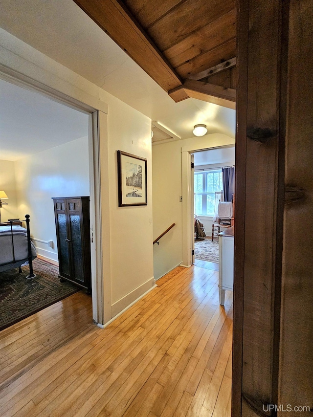 N15505 Black River Rd, Ironwood, MI 49938 - hallway with an upstairs landing, light wood-type flooring, baseboards, and wooden ceiling