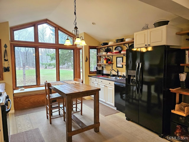 N15505 Black River Rd, Ironwood, MI 49938 - kitchen with black appliances, a sink, open shelves, vaulted ceiling, and pendant lighting