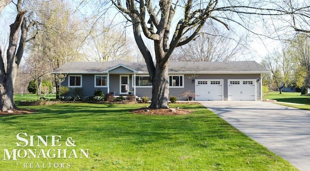ranch-style home with an attached garage, concrete driveway, and a front yard