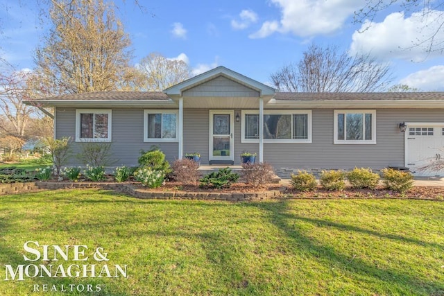 ranch-style house featuring a garage, a front yard, and covered porch