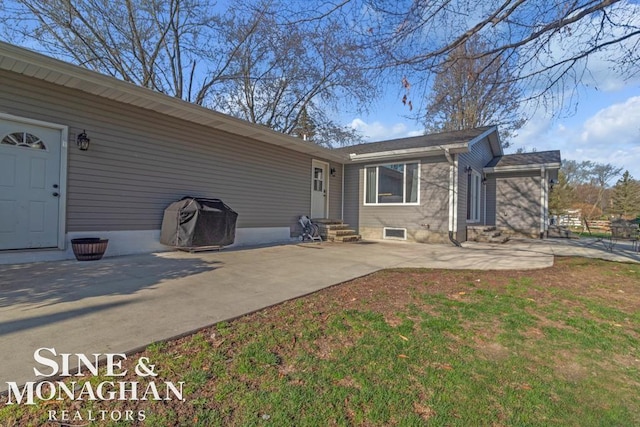 rear view of house featuring entry steps and a patio area