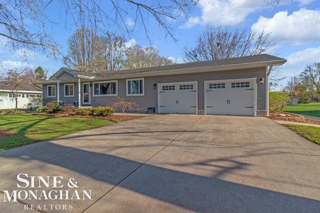 view of front of property with a garage, concrete driveway, and a front yard