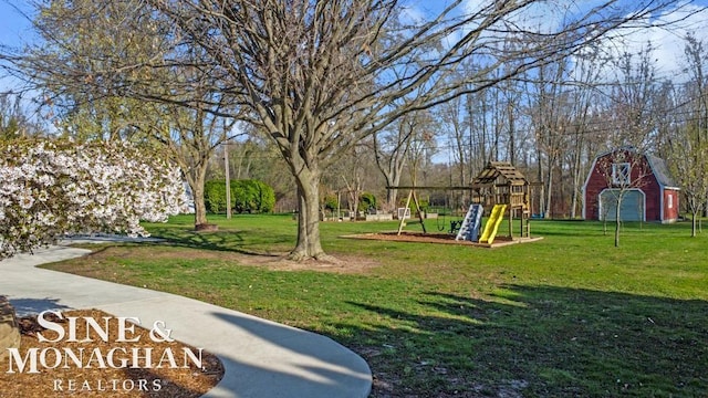 view of home's community with a yard, a playground, and a barn