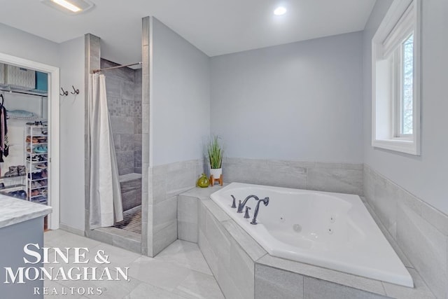 full bath with tiled shower, a tub with jets, and tile patterned flooring