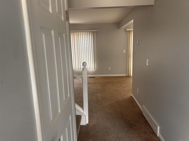 corridor with carpet, an upstairs landing, and baseboards