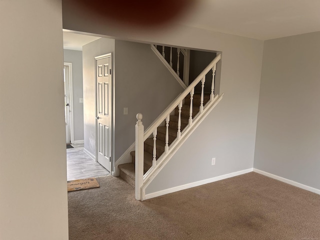 staircase with carpet flooring and baseboards