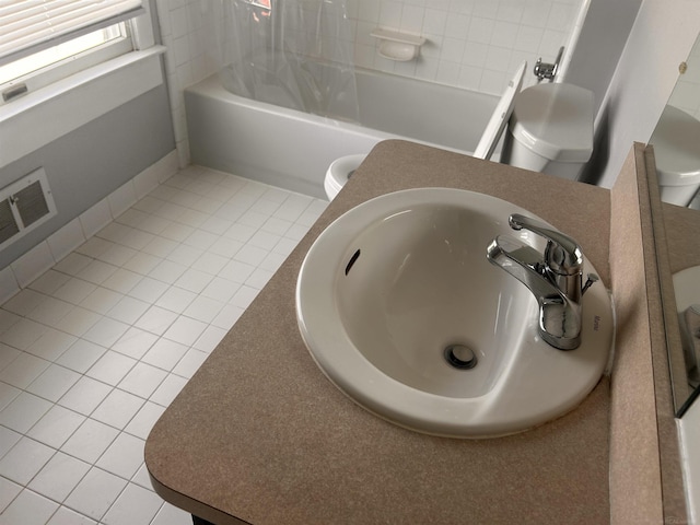 bathroom view of a sink, toilet, and tub / shower combination