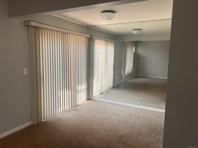 carpeted spare room with baseboards
