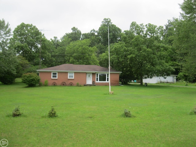 ranch-style house with a front yard and brick siding