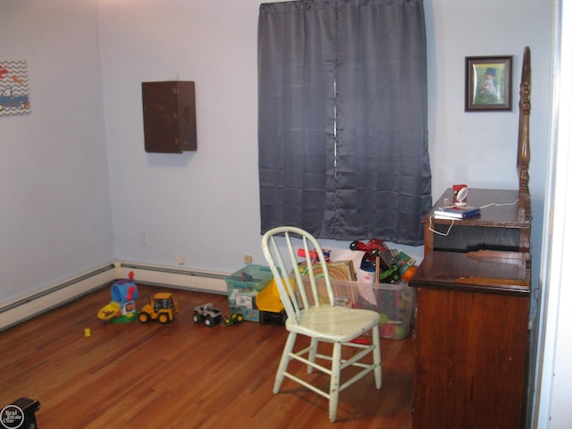 recreation room with wood finished floors and electric panel