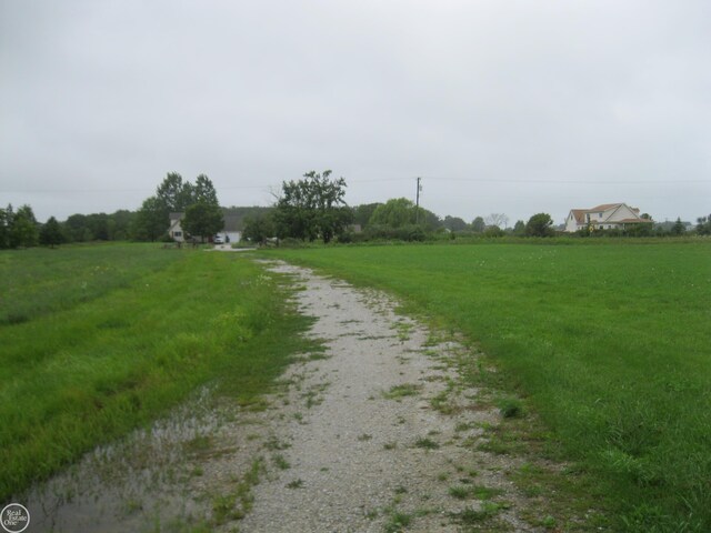 view of dirt / gravel road with a view of countryside